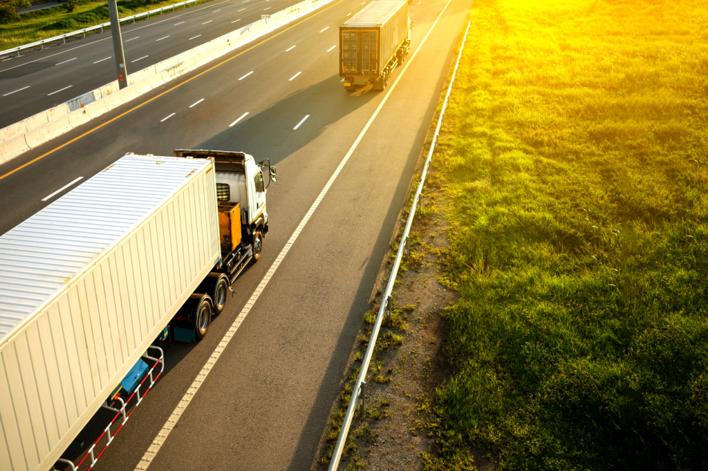 White truck on highway with container